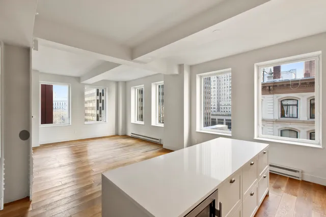 a picture of a room with a air conditioner and a white refrigerator