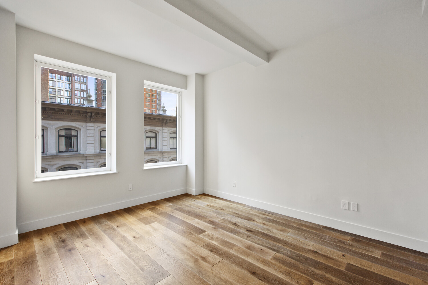 93 Worth Street, Unit 602 Manhattan, NY 10013 - Photo 3 of 8 a view of empty room with wooden floor and fan