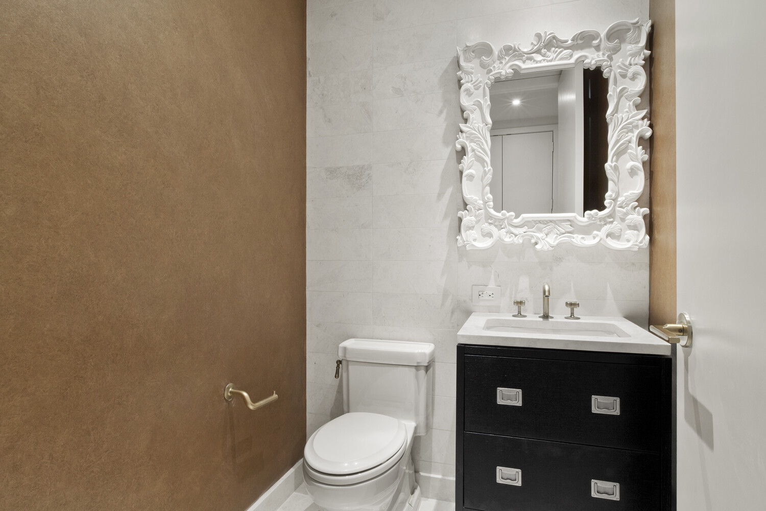 93 Worth Street, Unit 602 Manhattan, NY 10013 - Photo 6 of 8 a bathroom with a toilet sink and mirror