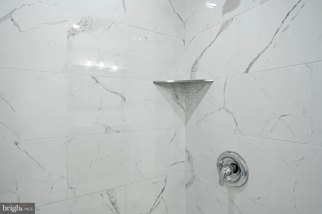 an empty room with wooden floor windows and ceiling fan