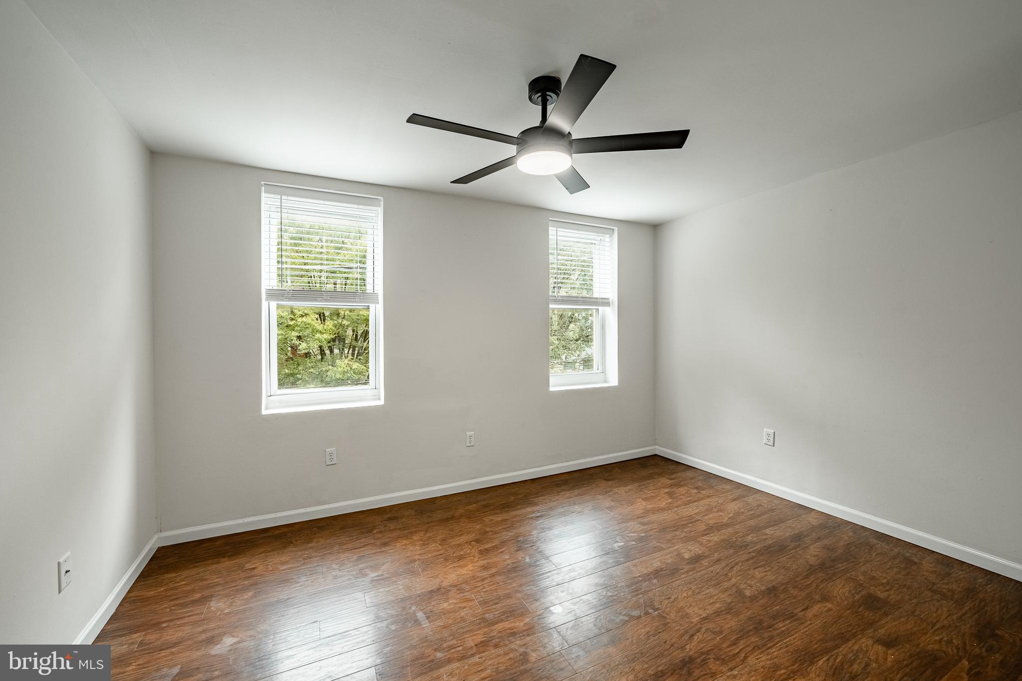 841 Perkiomen Street Philadelphia, PA 19130 - Photo 14 of 23 an empty room with wooden floor windows and ceiling fan