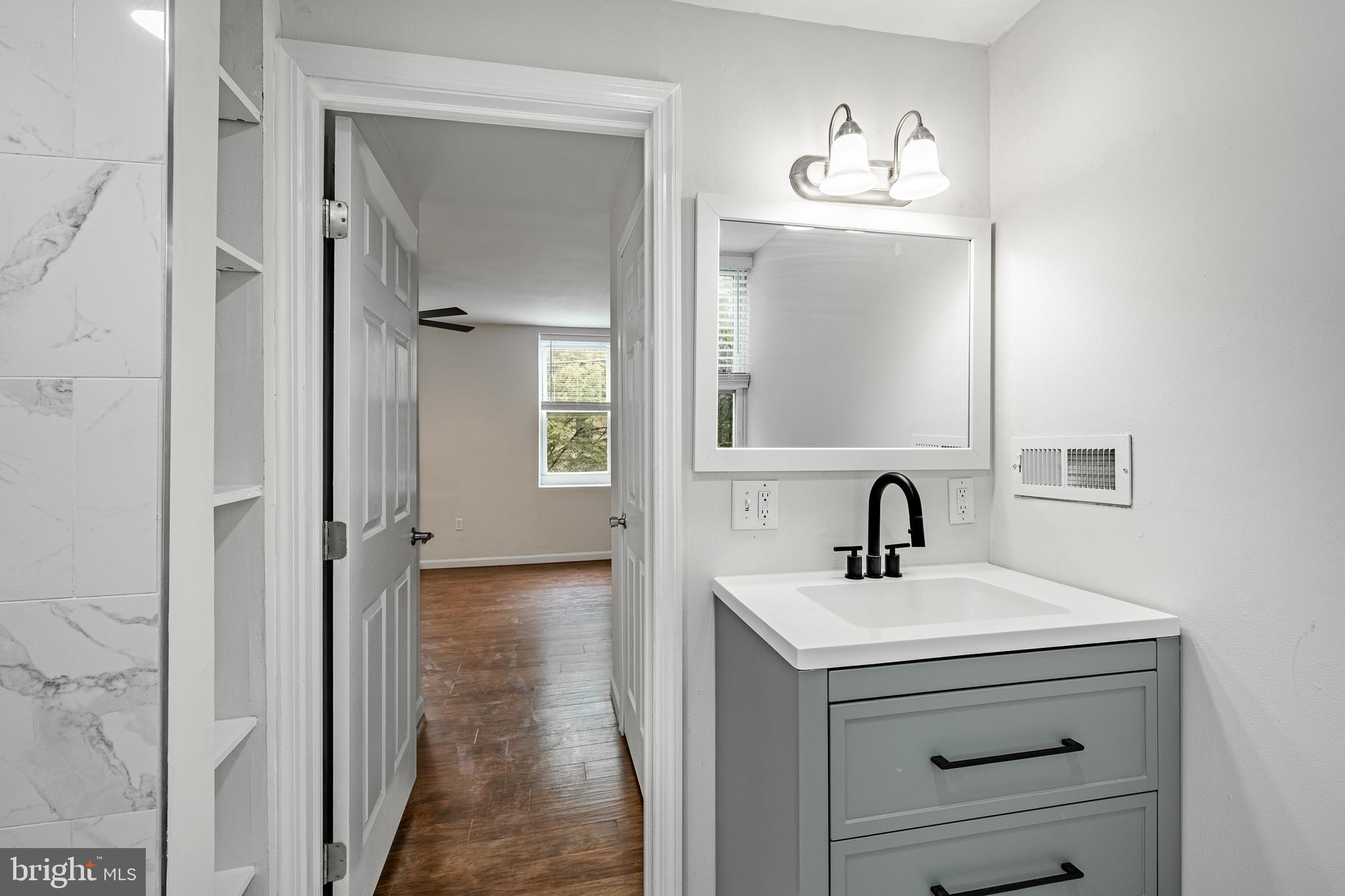 841 Perkiomen Street Philadelphia, PA 19130 - Photo 16 of 23 a bathroom with a sink a mirror and a vanity