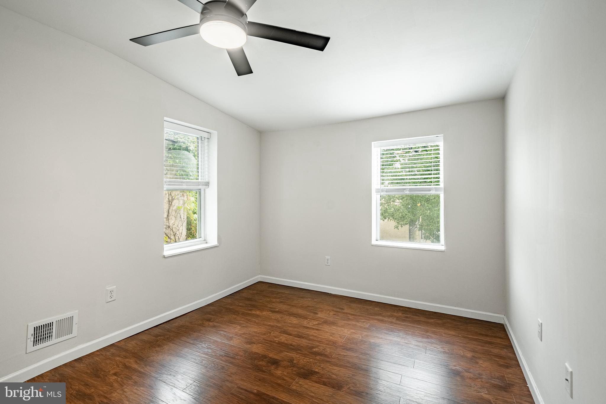 841 Perkiomen Street Philadelphia, PA 19130 - Photo 17 of 23 a view of an empty room with wooden floor and a window