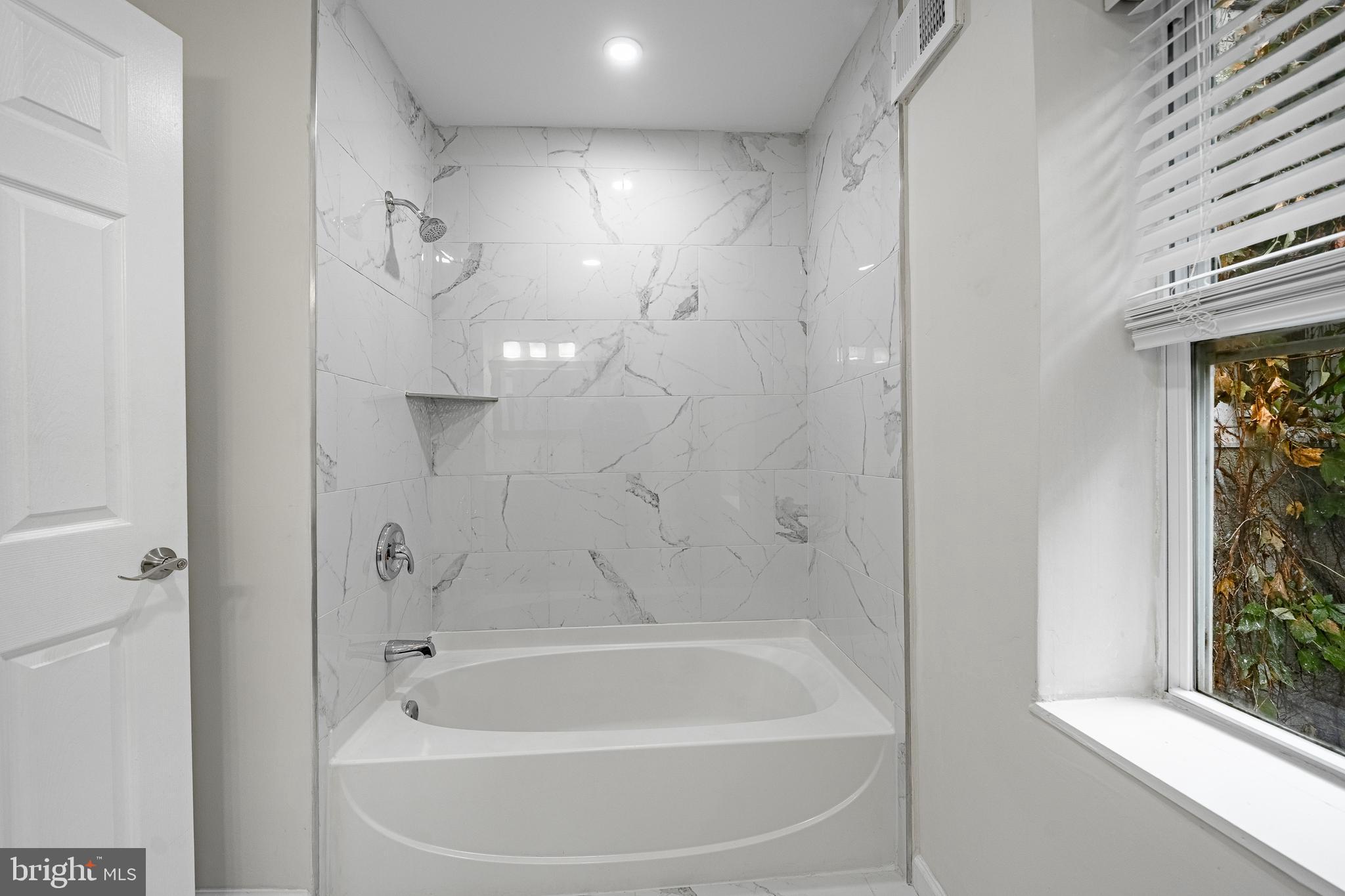 841 Perkiomen Street Philadelphia, PA 19130 - Photo 19 of 23 a white bath tub sitting next to a window