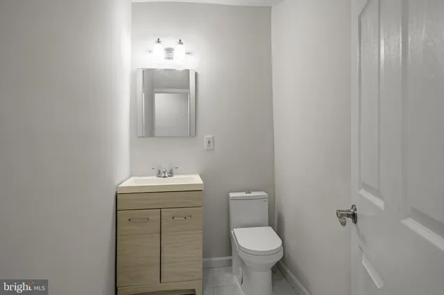 a bathroom with a sink toilet and mirror