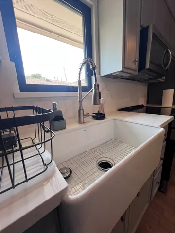 a kitchen with a sink a stove and a microwave