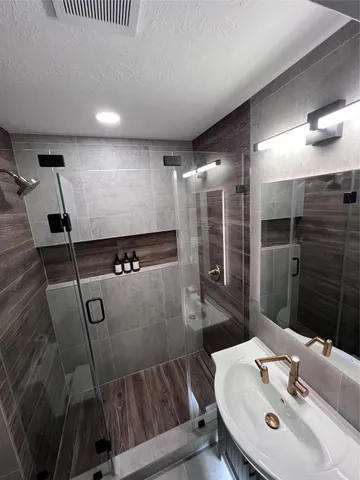 a bathroom with a sink and mirror