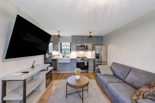 a living room with furniture and a chandelier