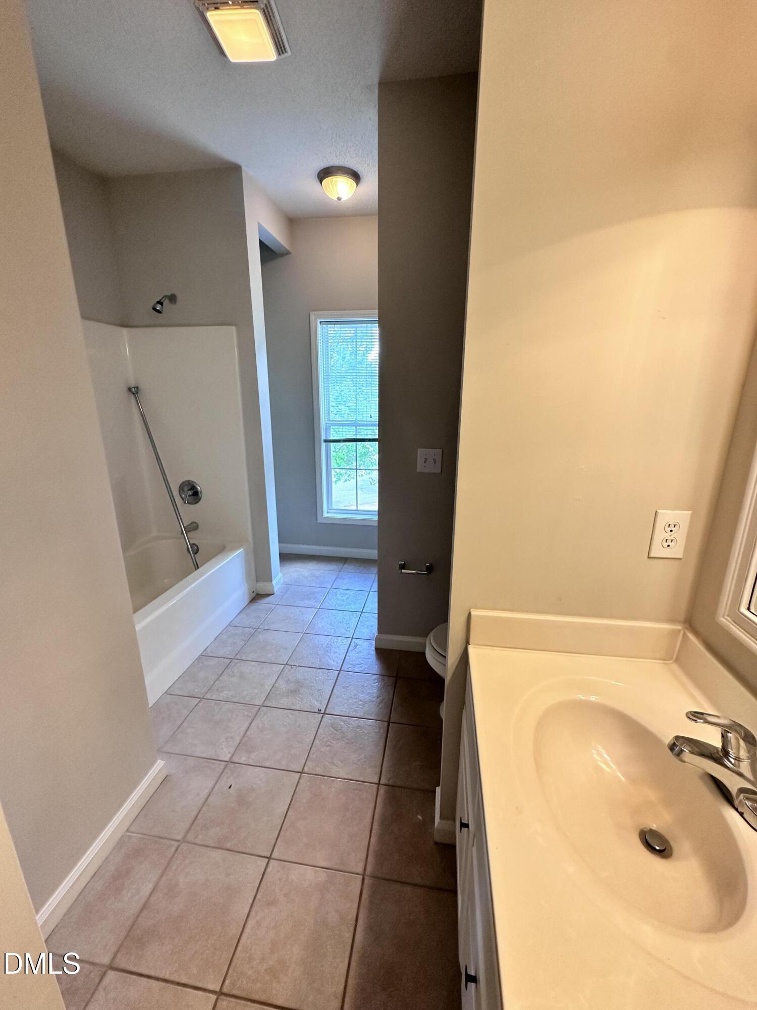 2511 Huntscroft Lane, Unit 203 Raleigh, NC 27617 - Photo 11 of 13 a bathroom with a sink and a tub