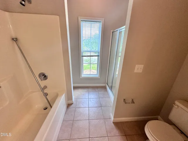 a bathroom with a double vanity sink a mirror and a shower