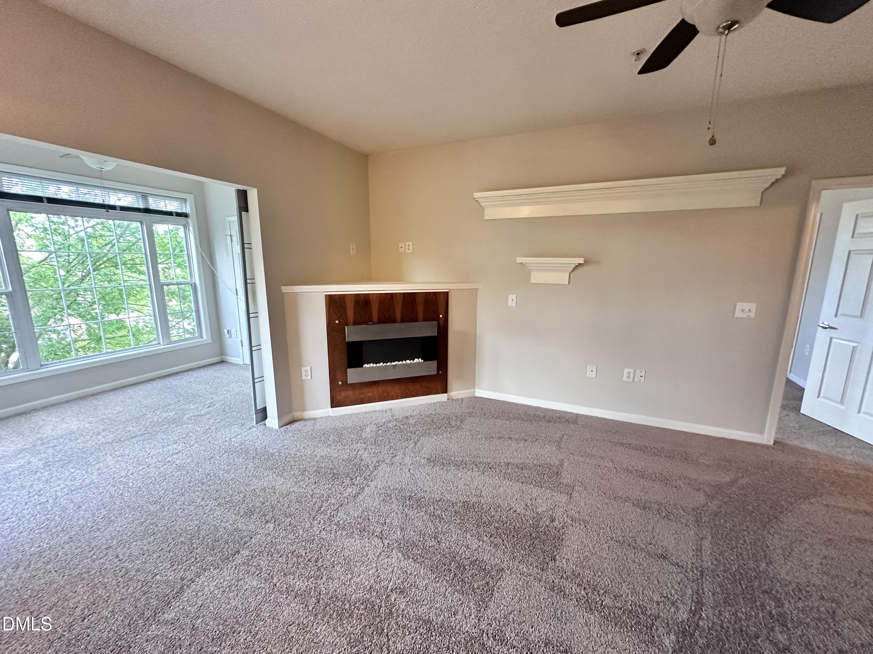 2511 Huntscroft Lane, Unit 203 Raleigh, NC 27617 - Photo 5 of 13 a view of empty room with a fireplace