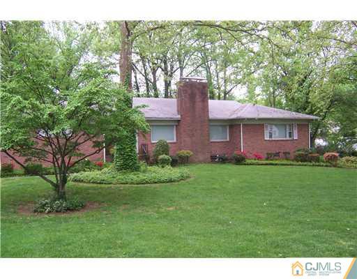 93 Stafford Road Colonia, NJ 07067 - Photo 1 of 2 a front view of a house with a garden