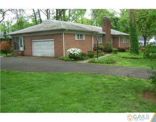 93 Stafford Road Colonia, NJ 07067 - Photo 2 of 2 a front view of a house with a garden