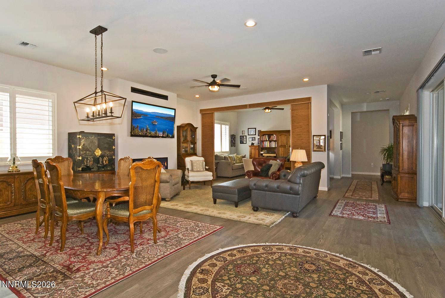 2332 Hammer Falls Drive Reno, NV 89521 - Photo 8 of 57 a living room with furniture a dining table and a chandelier