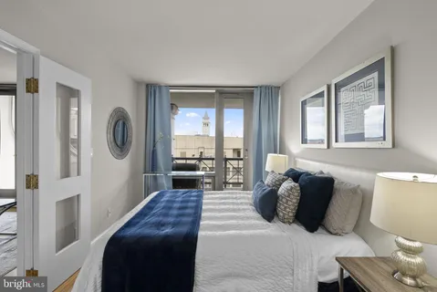 a bedroom with a large bed and a large window