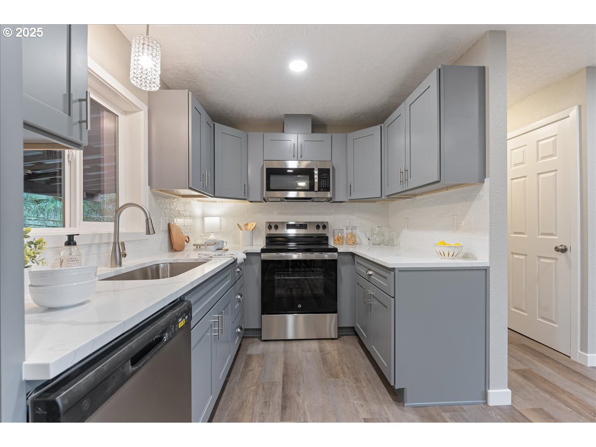 32900 Southeast Colorado Road Sandy, OR 97055 - Photo 12 of 38 a kitchen with granite countertop a sink and a stove top oven