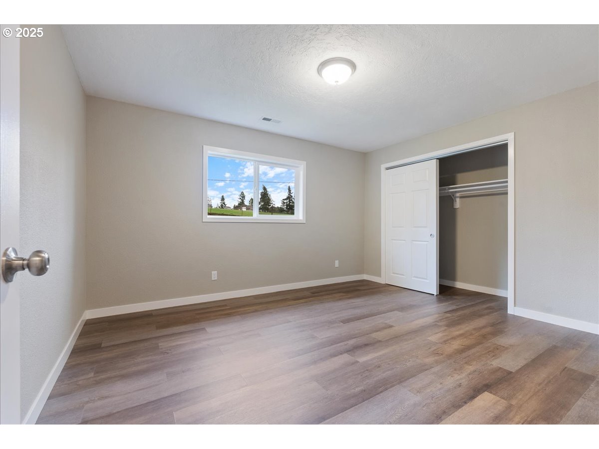 32900 Southeast Colorado Road Sandy, OR 97055 - Photo 17 of 38 a view of an empty room with wooden floor and a window