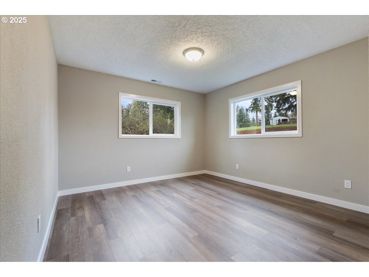 32900 Southeast Colorado Road Sandy, OR 97055 - Photo 18 of 38 a view of an empty room with wooden floor and a window