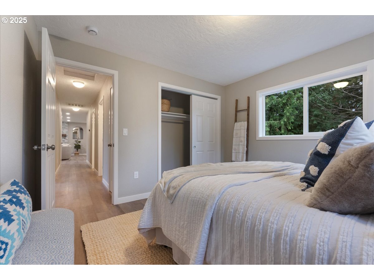 32900 Southeast Colorado Road Sandy, OR 97055 - Photo 21 of 38 a bedroom with a large bed and a large window