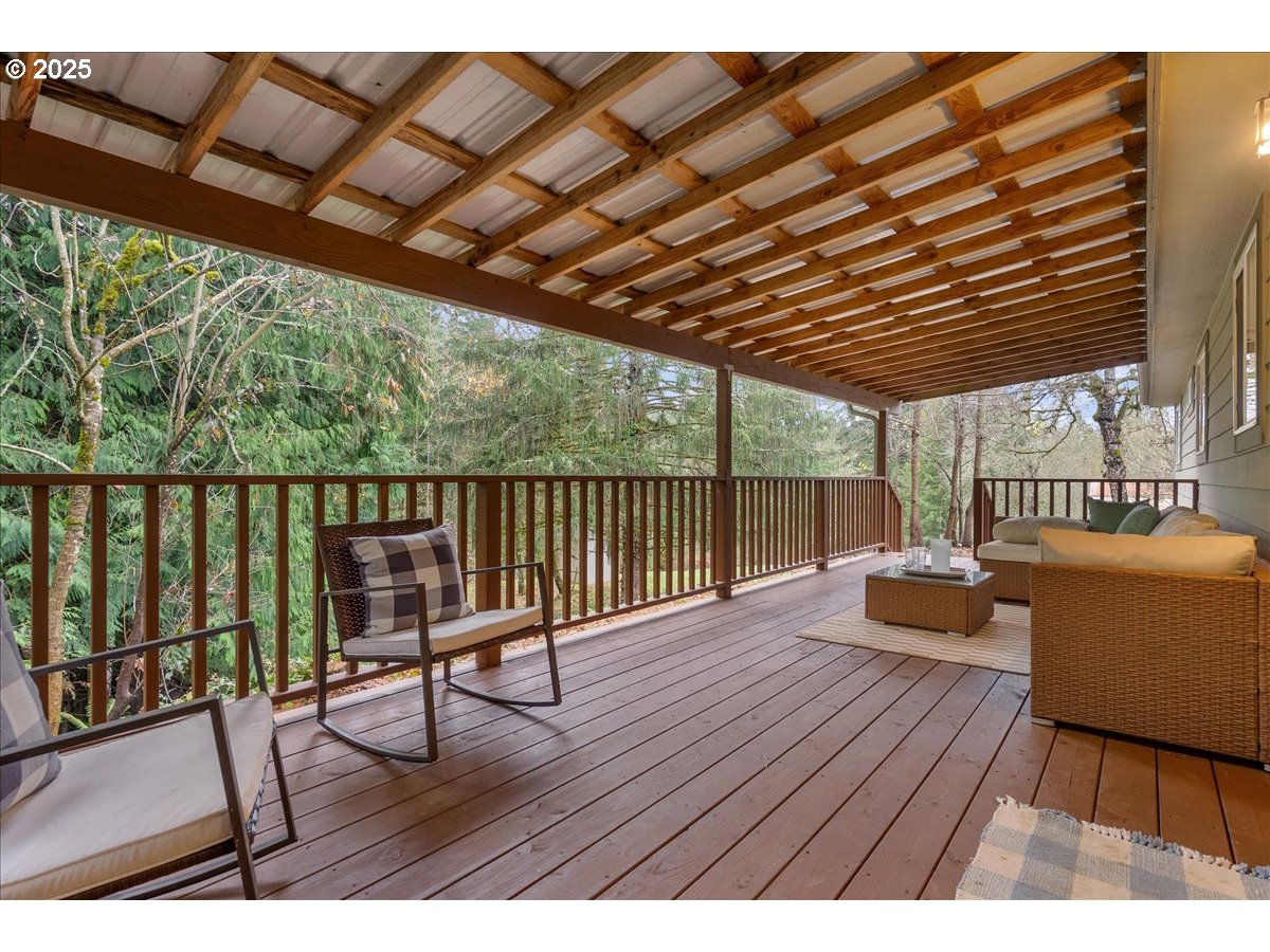 32900 Southeast Colorado Road Sandy, OR 97055 - Photo 22 of 38 a balcony with wooden floors and couch