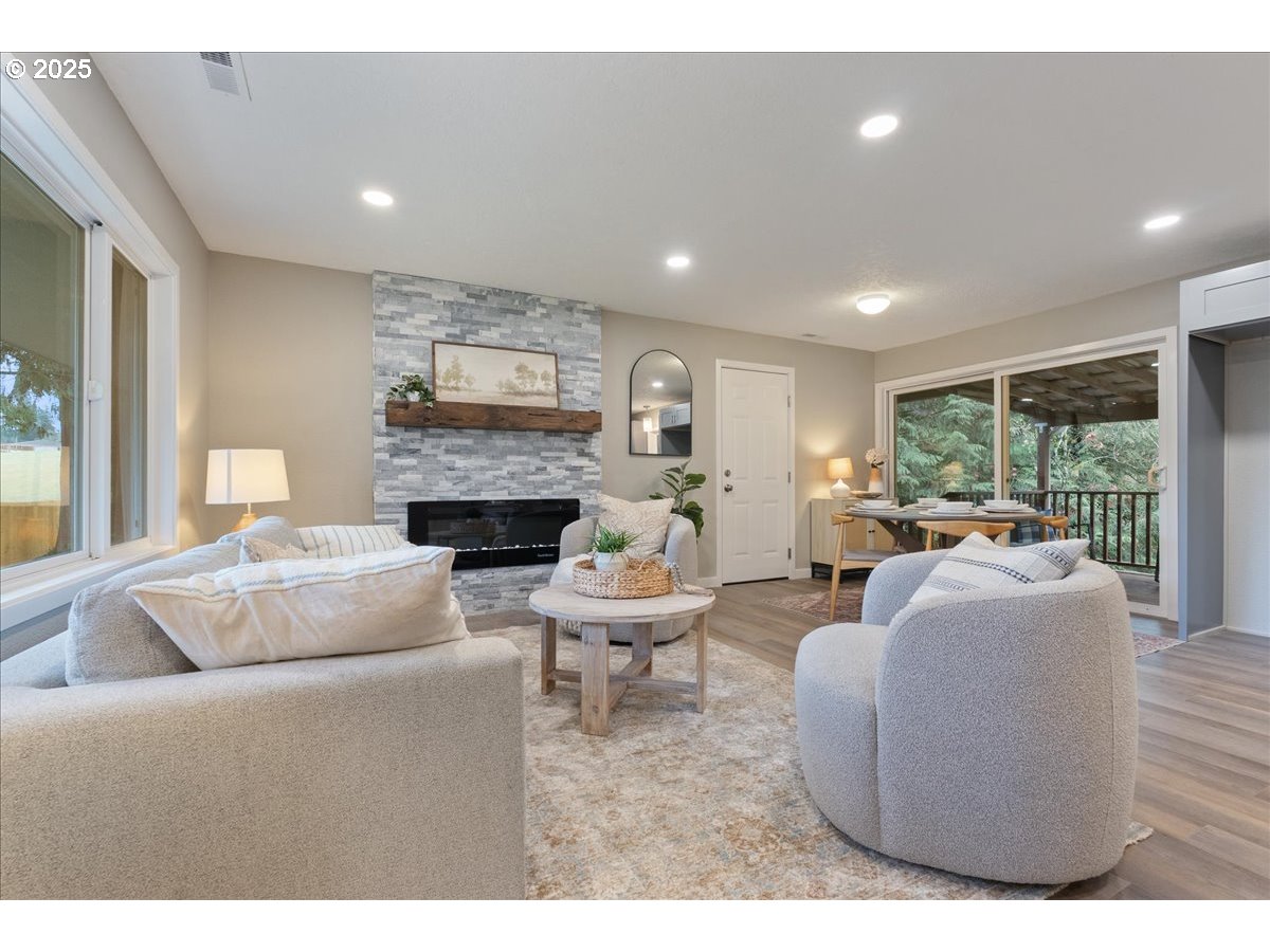 32900 Southeast Colorado Road Sandy, OR 97055 - Photo 5 of 38 a living room with furniture a fireplace and a large window