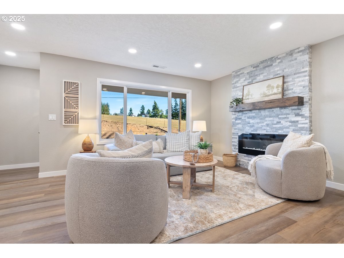 32900 Southeast Colorado Road Sandy, OR 97055 - Photo 6 of 38 a living room with furniture a fireplace and a large window