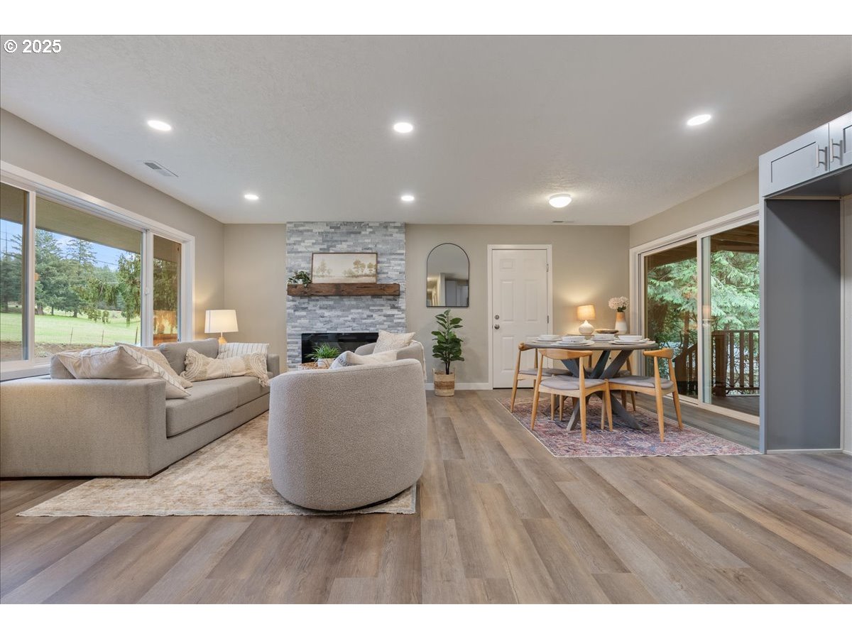32900 Southeast Colorado Road Sandy, OR 97055 - Photo 8 of 38 a living room with furniture a fireplace a flat screen tv and a large window