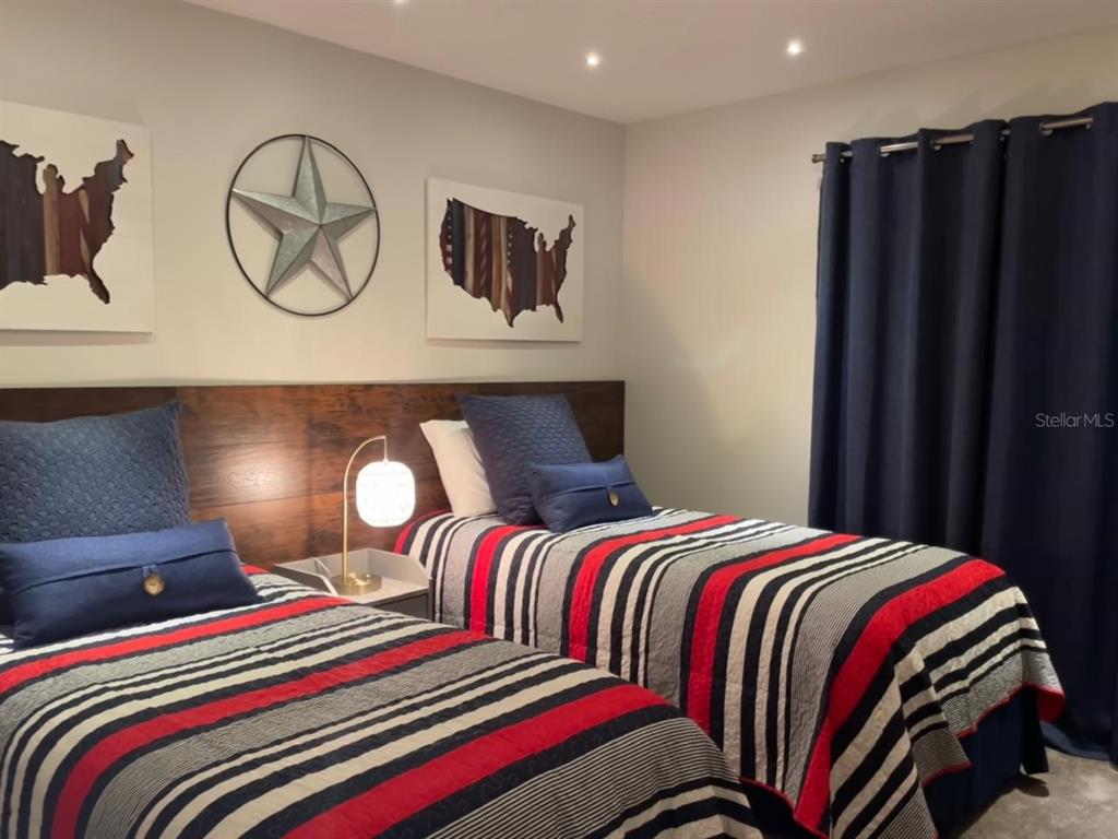 8979 California Palm Road Kissimmee, FL 34747 - Photo 12 of 33 a bedroom with a bed and lamps