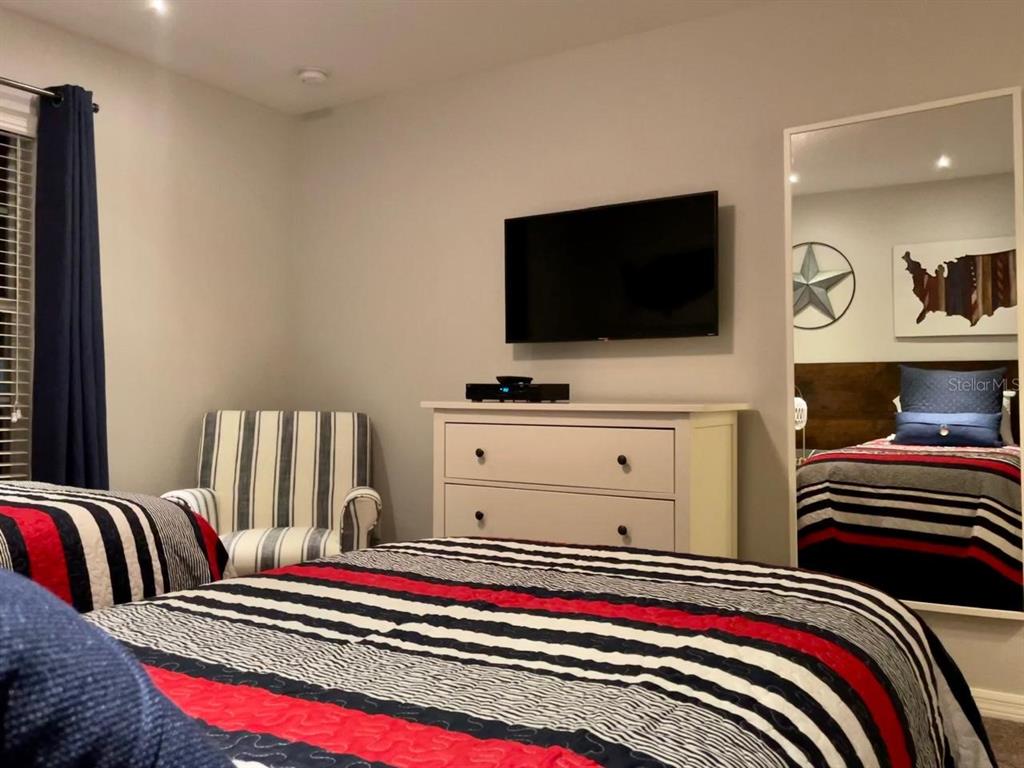 8979 California Palm Road Kissimmee, FL 34747 - Photo 13 of 33 a living room with furniture and a flat screen tv