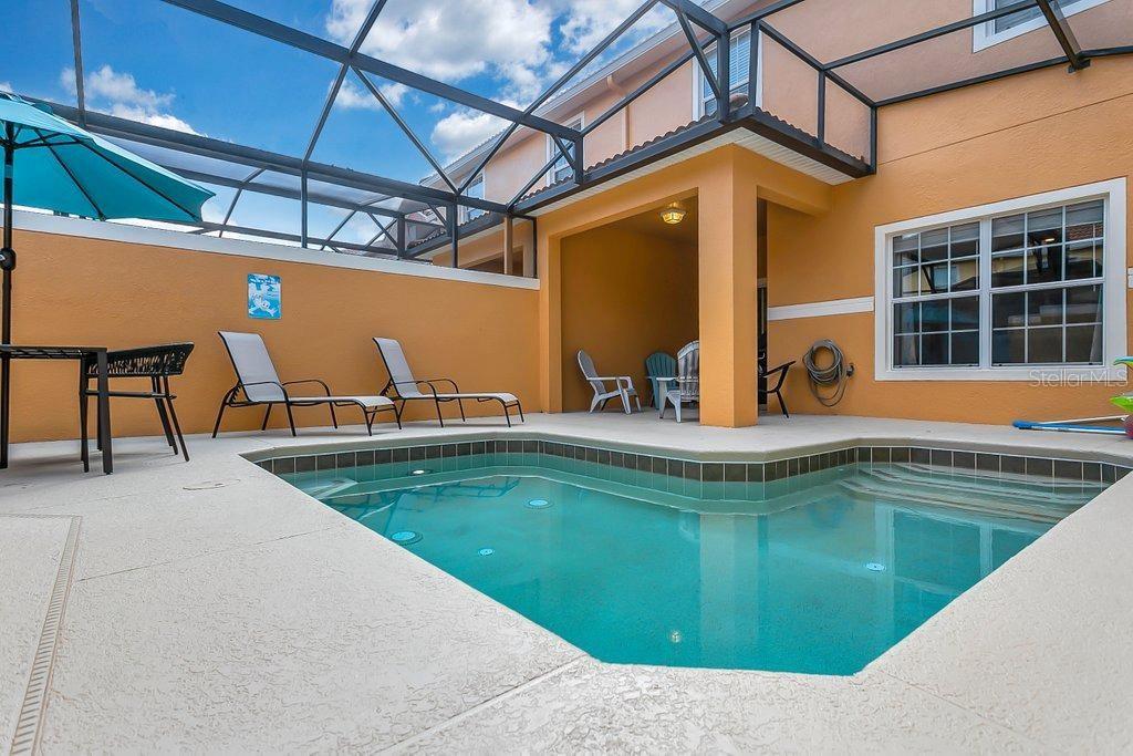 8979 California Palm Road Kissimmee, FL 34747 - Photo 15 of 33 a view of a swimming pool with a lounge chair