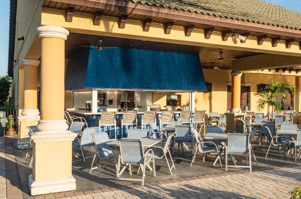 8979 California Palm Road Kissimmee, FL 34747 - Photo 17 of 33 a view of a patio with table and chairs and potted plants