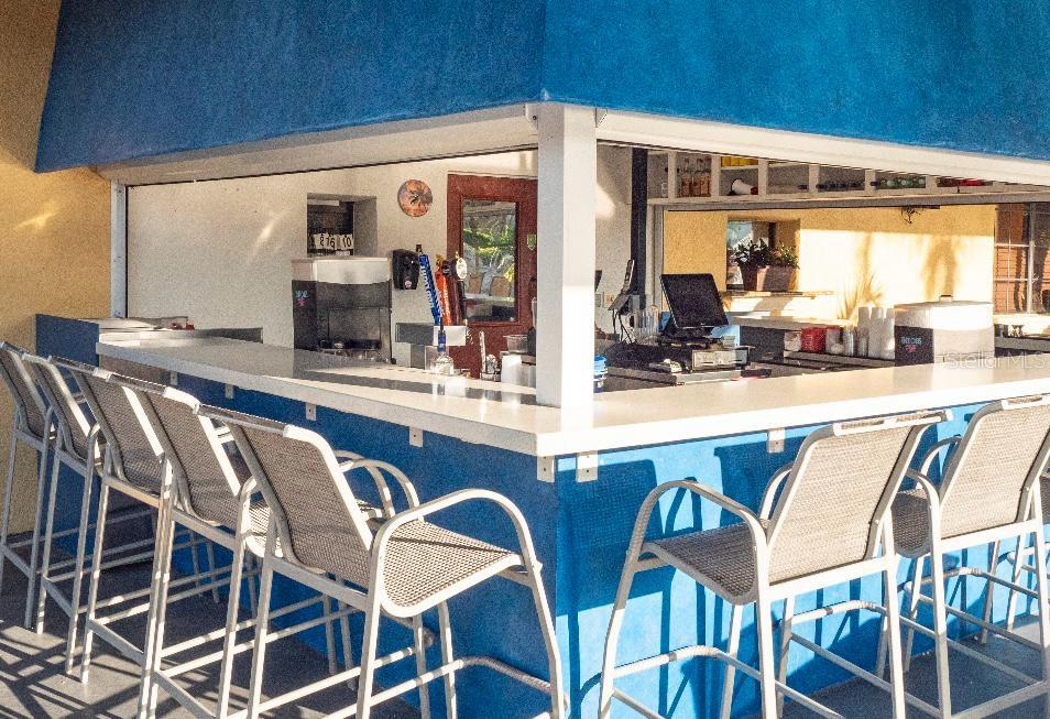 8979 California Palm Road Kissimmee, FL 34747 - Photo 19 of 33 a dining table with chairs and view of kitchen