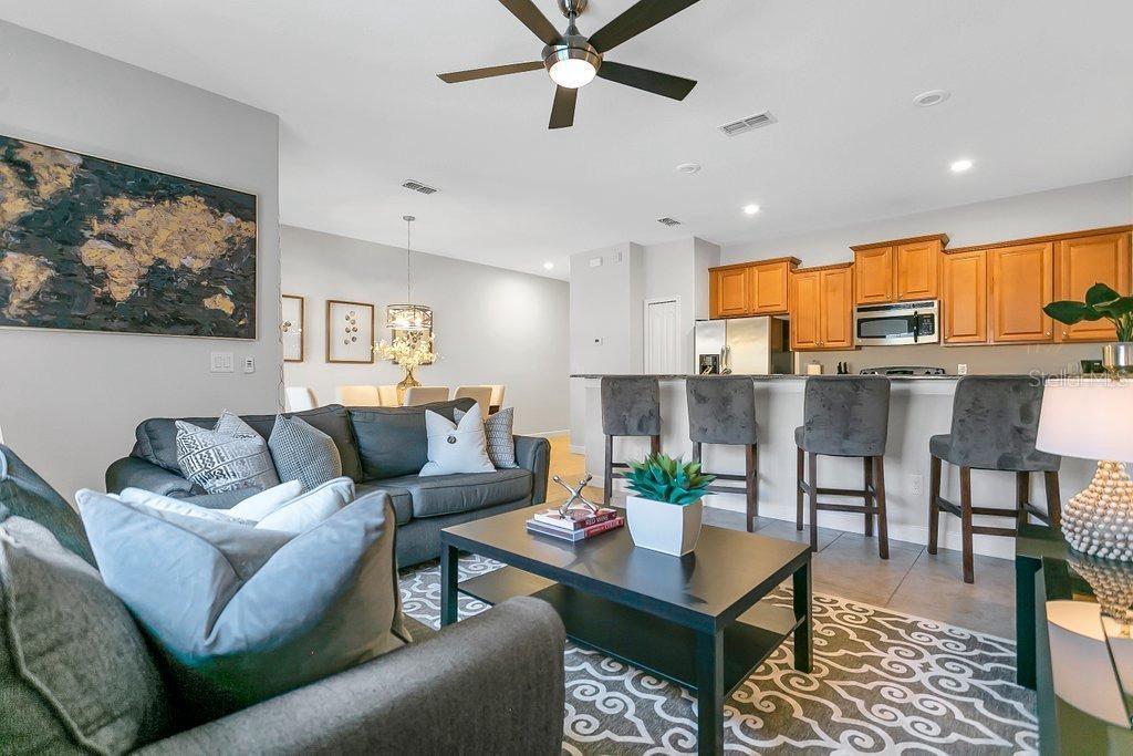 8979 California Palm Road Kissimmee, FL 34747 - Photo 2 of 33 a living room with furniture kitchen view and a large window