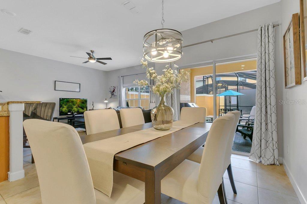 8979 California Palm Road Kissimmee, FL 34747 - Photo 5 of 33 a view of a dining room with furniture wooden floor and chandelier