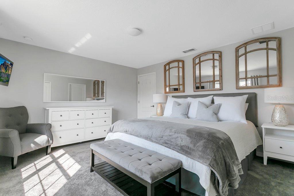 8979 California Palm Road Kissimmee, FL 34747 - Photo 9 of 33 a bedroom with a bed and a couch