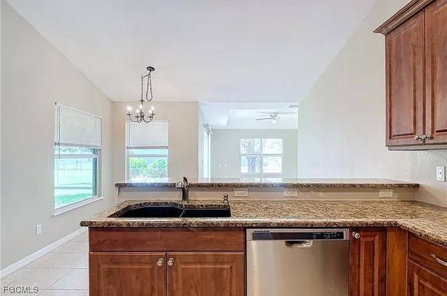 a kitchen with granite countertop a sink and a window