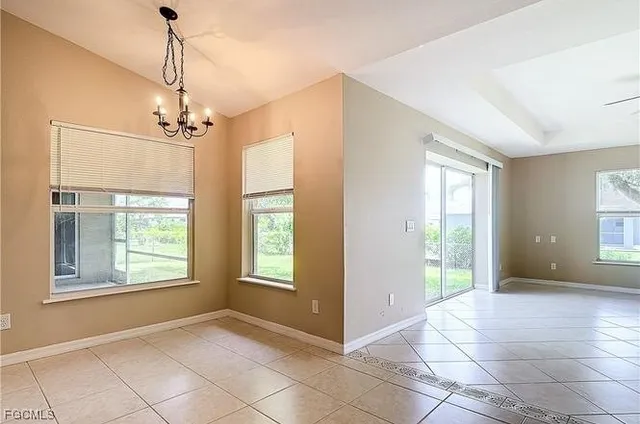 a view of livingroom with window chandelier and front door