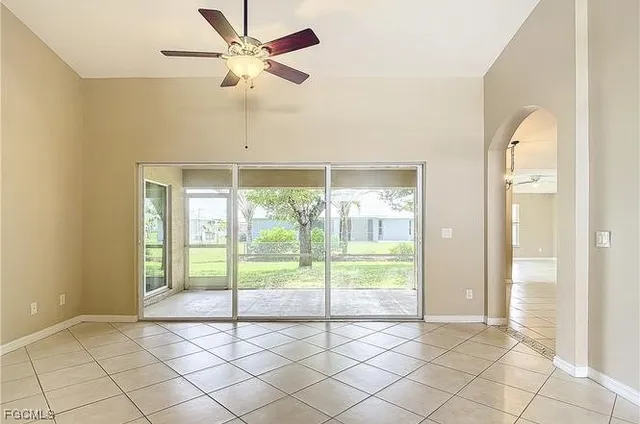 a view of an empty room and window ceiling fan