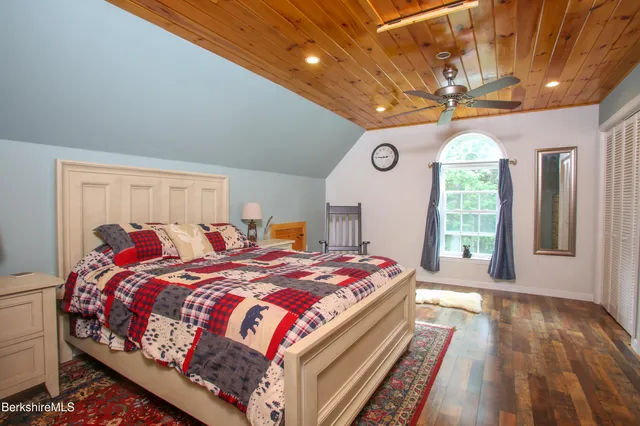 a bedroom with a large bed and a large window