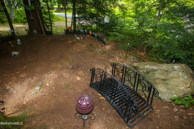a view of a pathway with a wrought fence