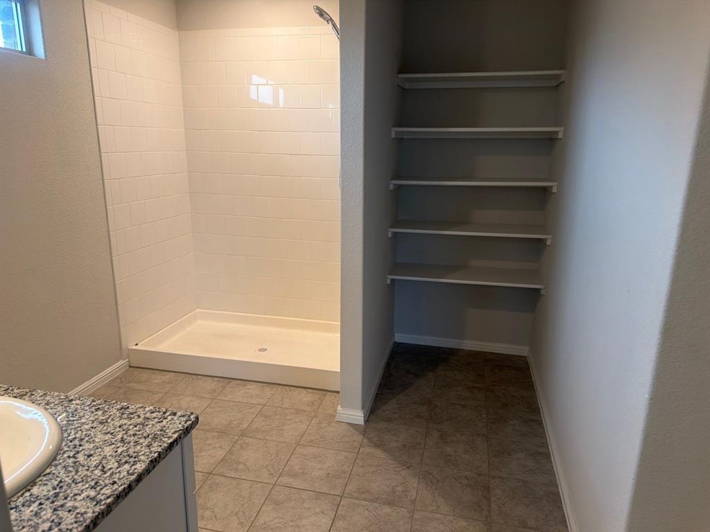 721 Durango Lane Cleburne, TX 76033 - Photo 9 of 25 a view of walk in closet with empty racks