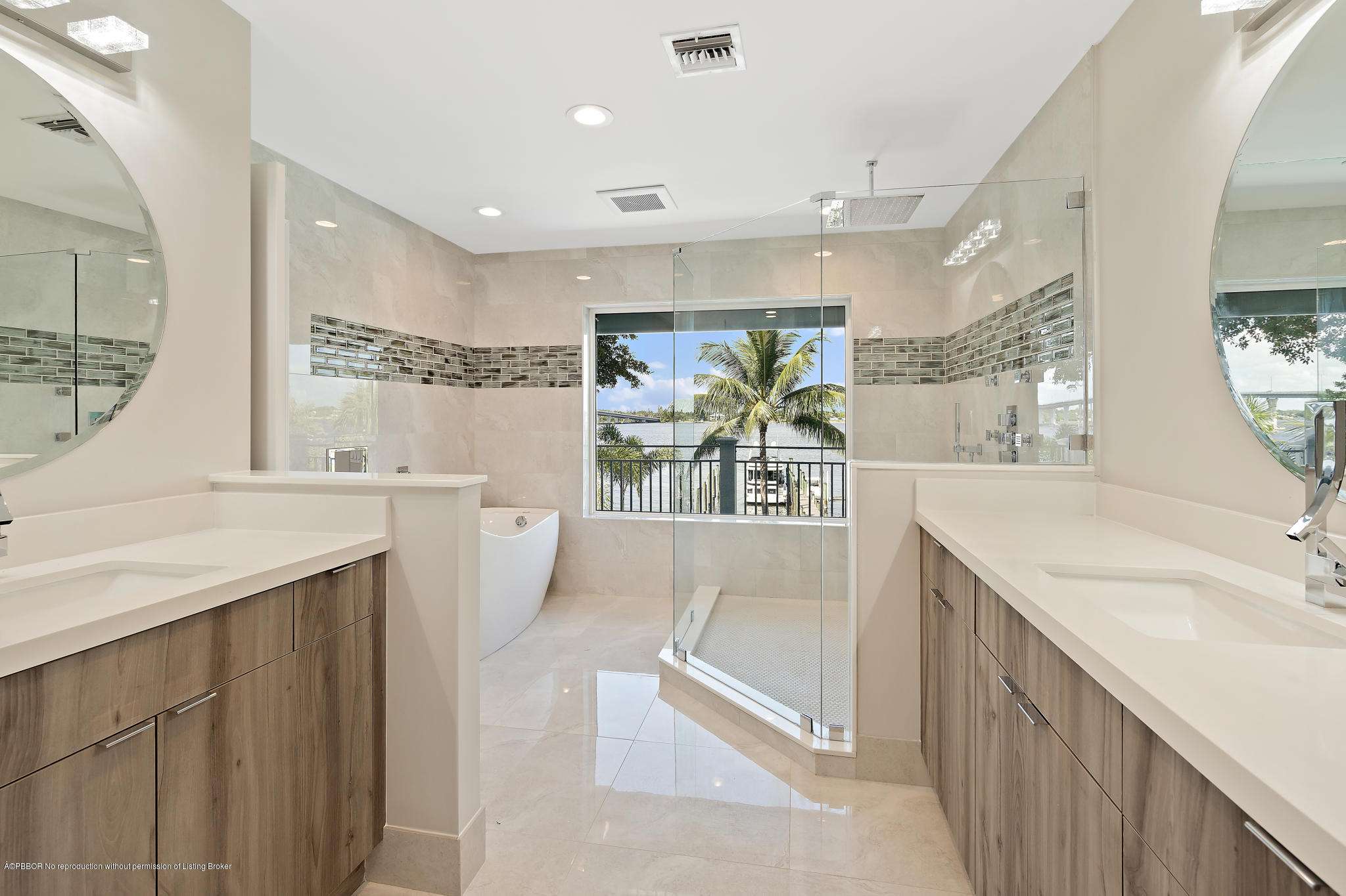 19 North River Road Sewall's Point, FL 34996 - Photo 24 of 51 a bathroom with a sink a large mirror and a bathtub