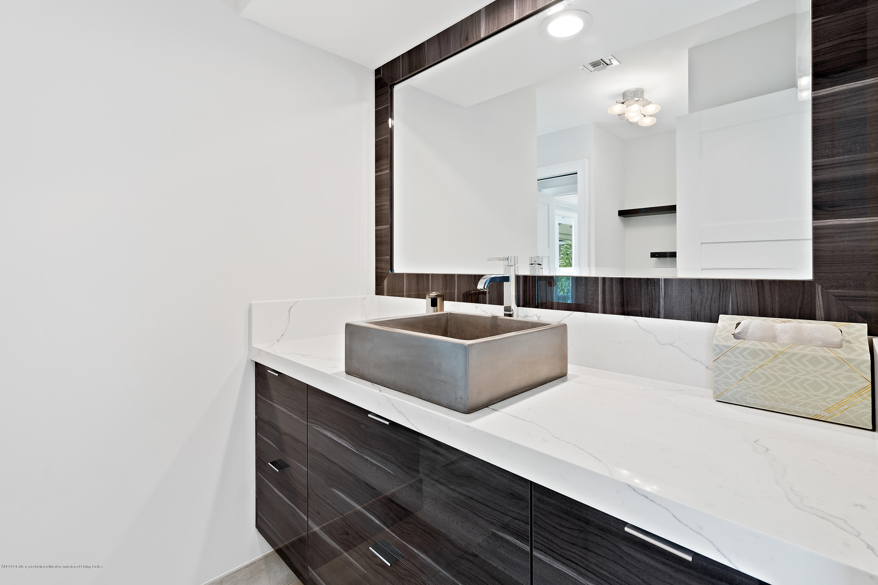 19 North River Road Sewall's Point, FL 34996 - Photo 8 of 51 a bathroom with a sink and a mirror