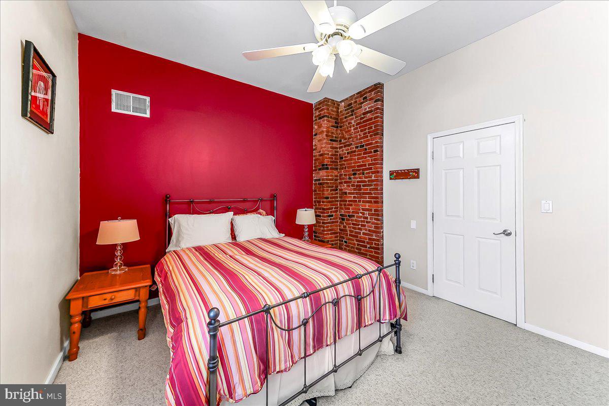 102 Church Street, Unit 402 Philadelphia, PA 19106 - Photo 12 of 24 a bedroom with a bed and a chandelier