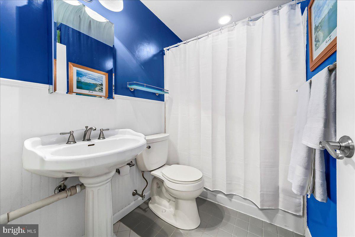 102 Church Street, Unit 402 Philadelphia, PA 19106 - Photo 13 of 24 a bathroom with a sink a toilet and a mirror