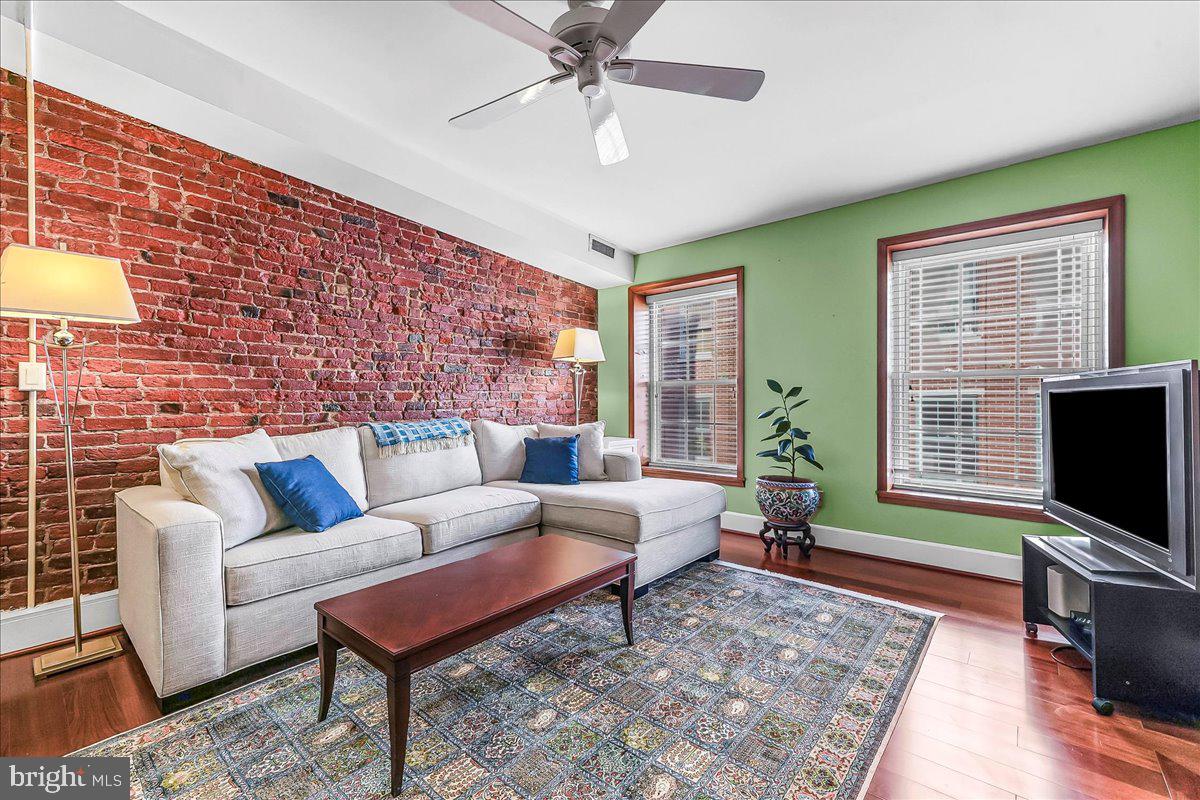 102 Church Street, Unit 402 Philadelphia, PA 19106 - Photo 3 of 24 a living room with furniture and a flat screen tv