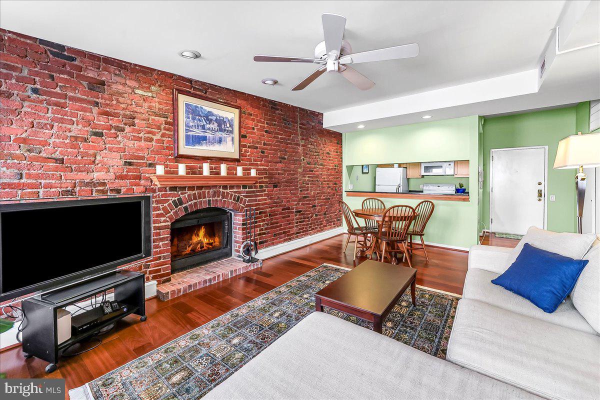 102 Church Street, Unit 402 Philadelphia, PA 19106 - Photo 5 of 24 a living room with furniture a flat screen tv and a fireplace