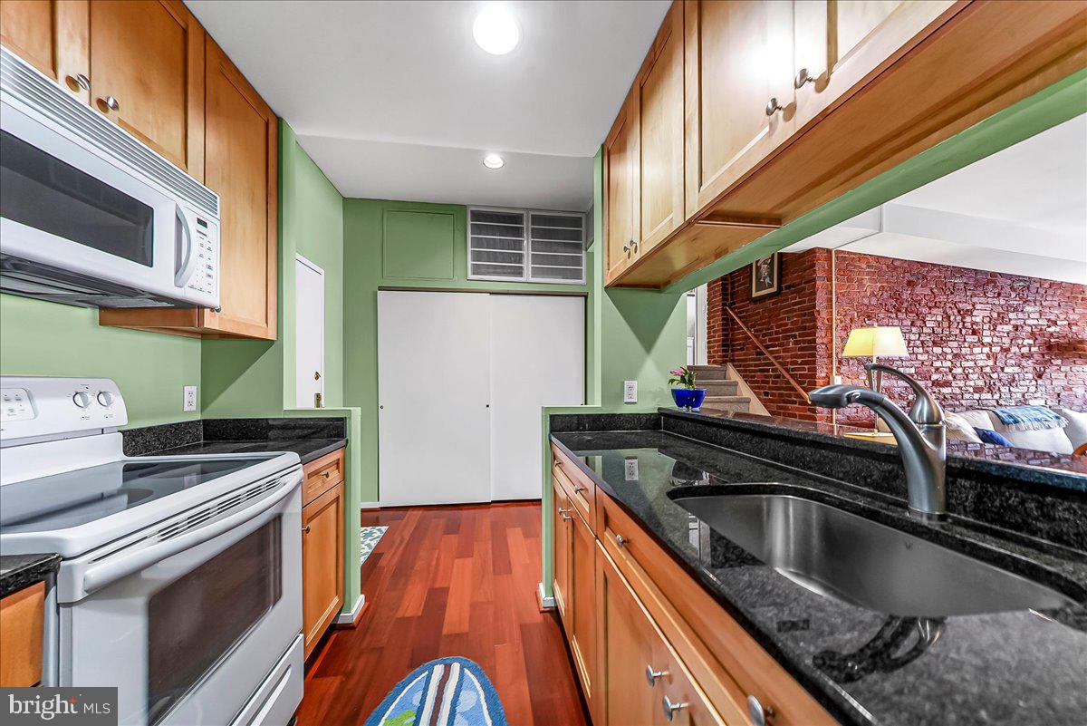 102 Church Street, Unit 402 Philadelphia, PA 19106 - Photo 9 of 24 a kitchen with stainless steel appliances granite countertop a sink and a stove