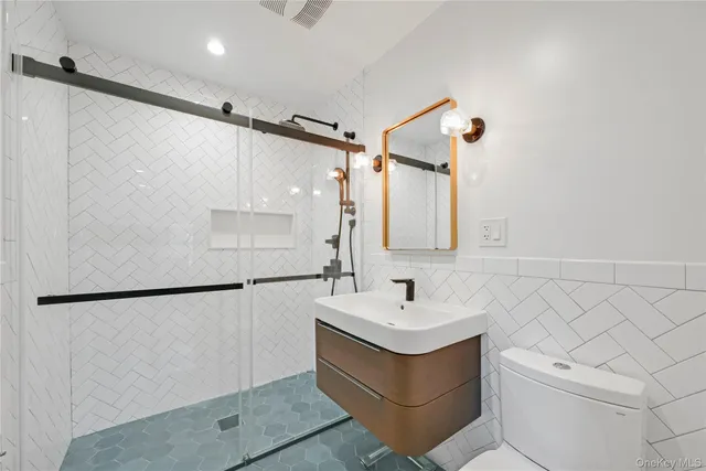a bathroom with a sink toilet and shower