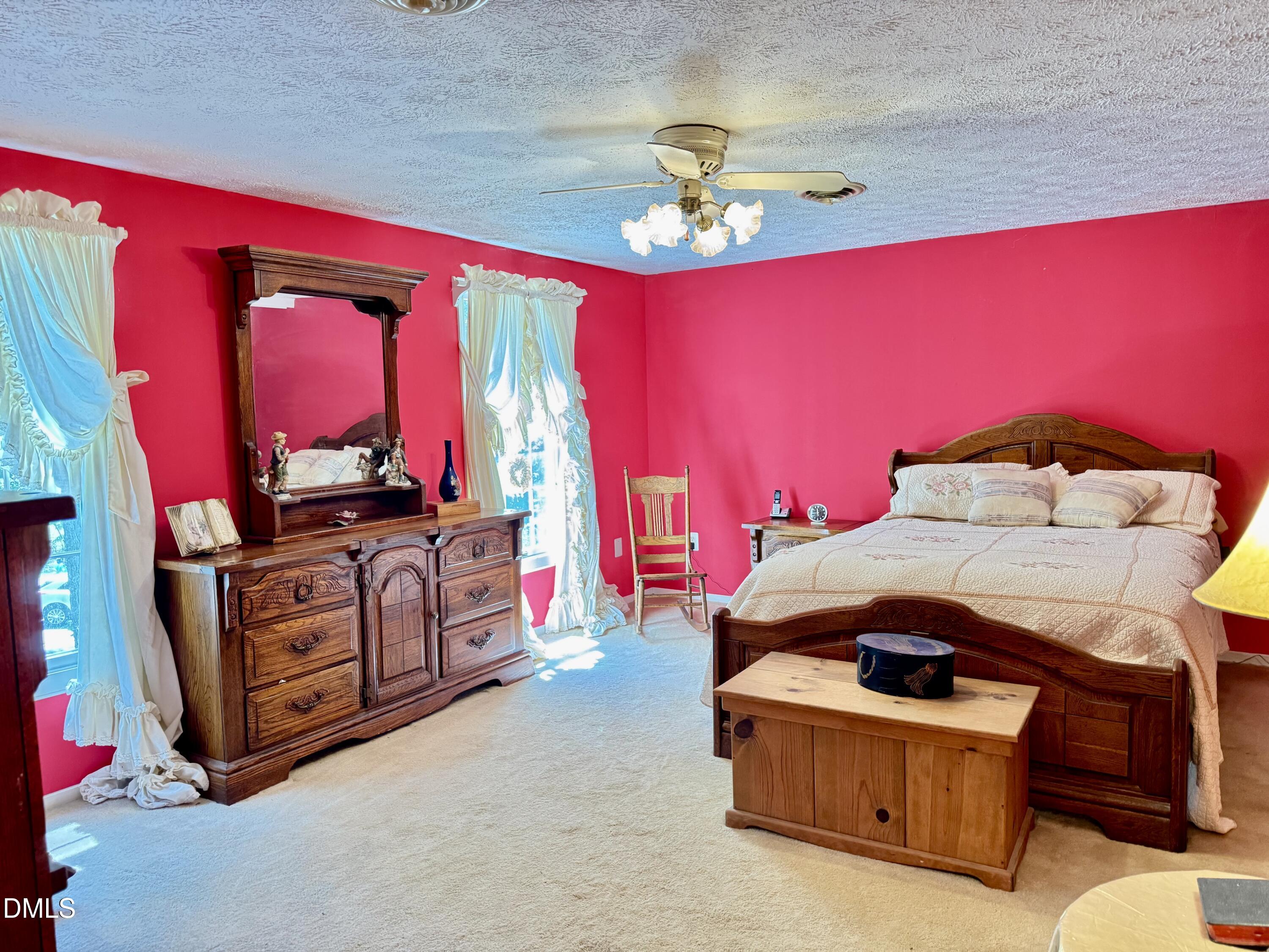 84 Wintergreen Road Henderson, NC 27537 - Photo 20 of 49 a living room with furniture and a dresser